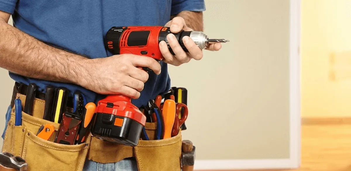 Handyman holding a power drill for home repairs and installations in San Antonio, TX